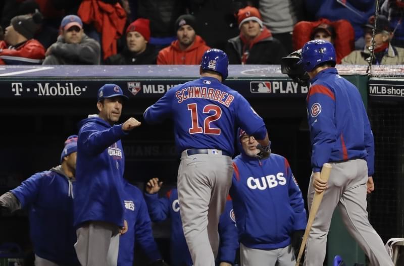 Chicago Cubs' Kyle Schwarber celebrates in the dugout after gets walked in during the fifth inning of Game 2 of the World Series against the Cleveland Indians Wednesday, Oct. 26, 2016, in Cleveland