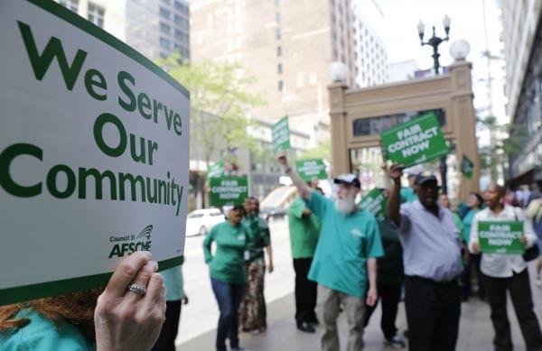 In this June 9, 2015 photo, members of the American Federation of State, County and Municipal Employees protest in Chicago.