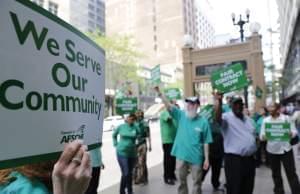 In this June 9, 2015 photo, members of the American Federation of State, County and Municipal Employees protest in Chicago.