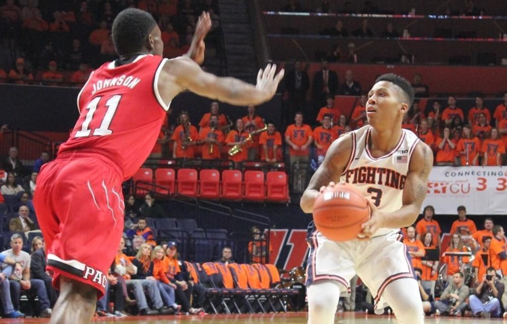 llini Te'Jon Lucas looks to pass against NC state defender Markell Johnson, Tuesday night in Champaign