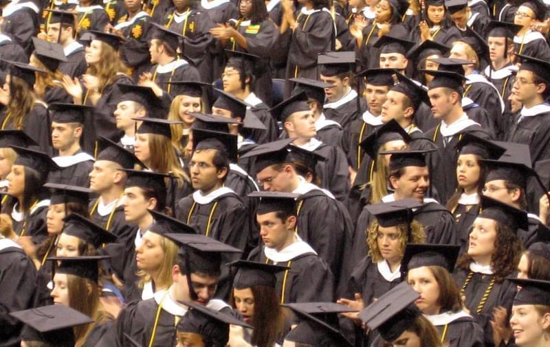 College students in caps and gowns for graduation ceremony.