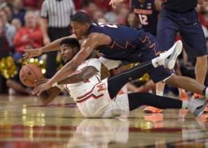 Illinois guard Malcolm Hill, top, fights for the ball against Maryland guard Dion Wiley, bottom, during the first half of an NCAA college basketball game, Tuesday, Dec. 27, 2016, in College Park, Md.