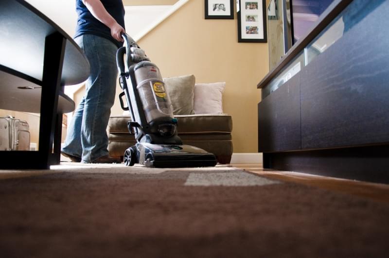 person vacuuming the floor