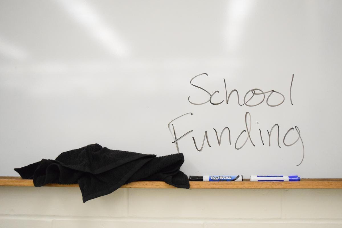 White board with school funding written on it.