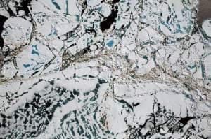 Chunks of Arctic sea ice, melt ponds and open water are all seen in this image captured by NASA's Digital Mapping System instrument during an Operation IceBridge flight over the Chukchi Sea in July 2016. 