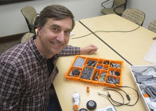 Joe Muskin with the University of Illinois College of Engineering looks up from an array of Lego Mindstorms components.
