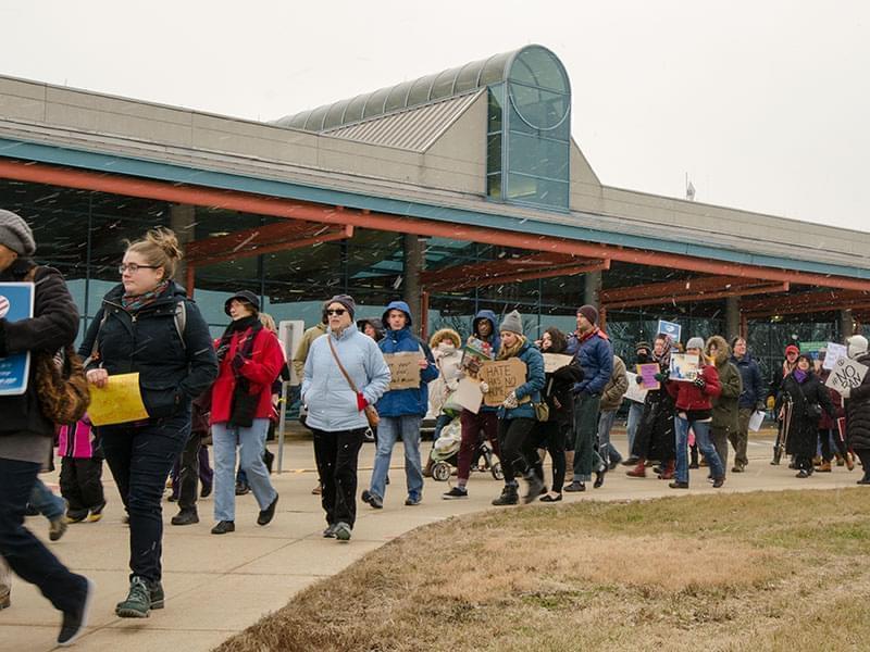 A rally protesting President Trump's travel ban affecting many majority Muslim countries at Willard Airport on Sunday attracted an estimated 600 participants.