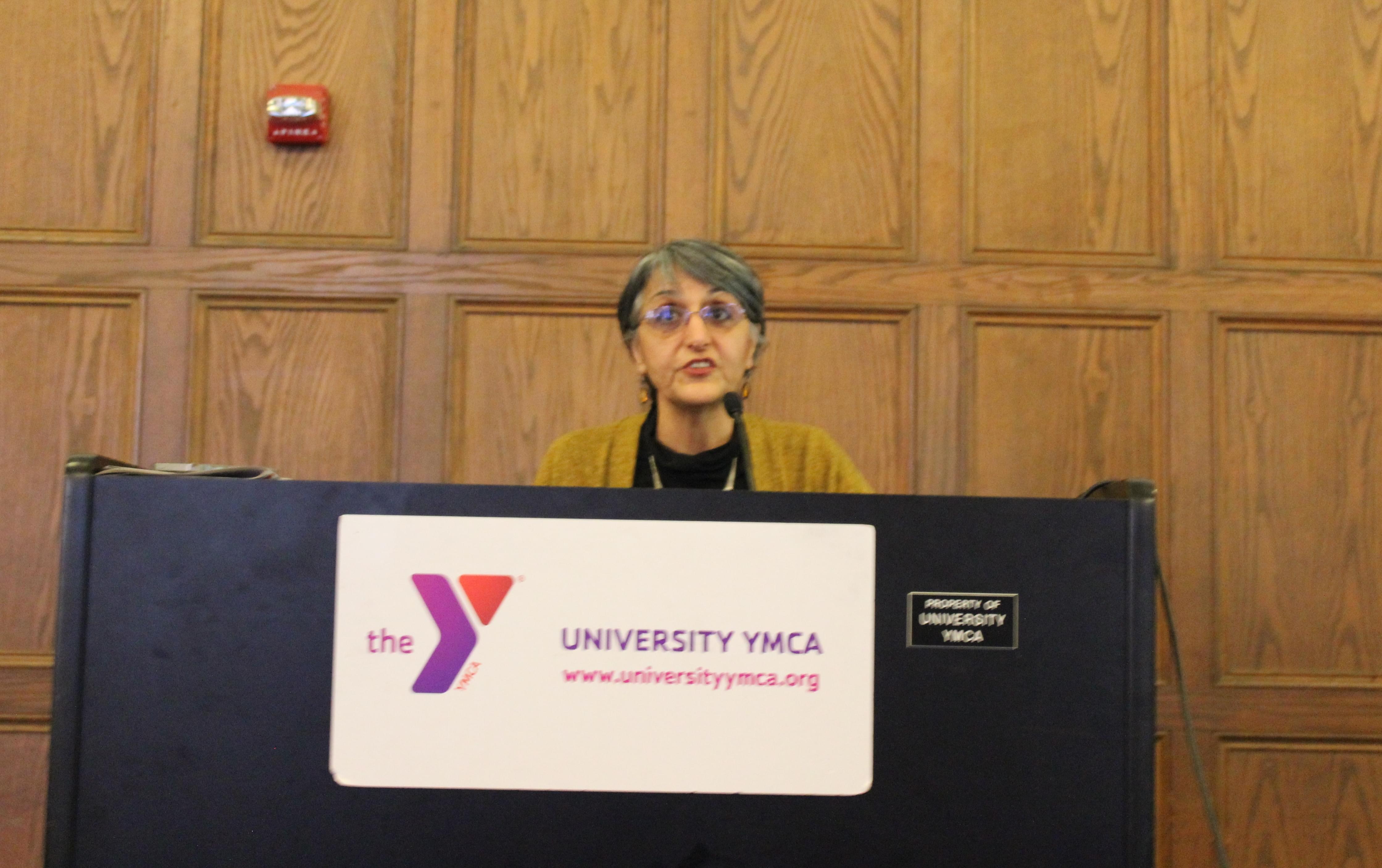 U of I Urban and Regional Planning Professor Faranak Miraftab discusses her research of Beardstown at the University YMCA Friday.