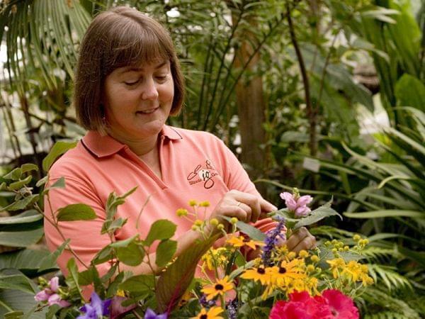Dianne Noland, host of Mid-American Gardener examining a plant