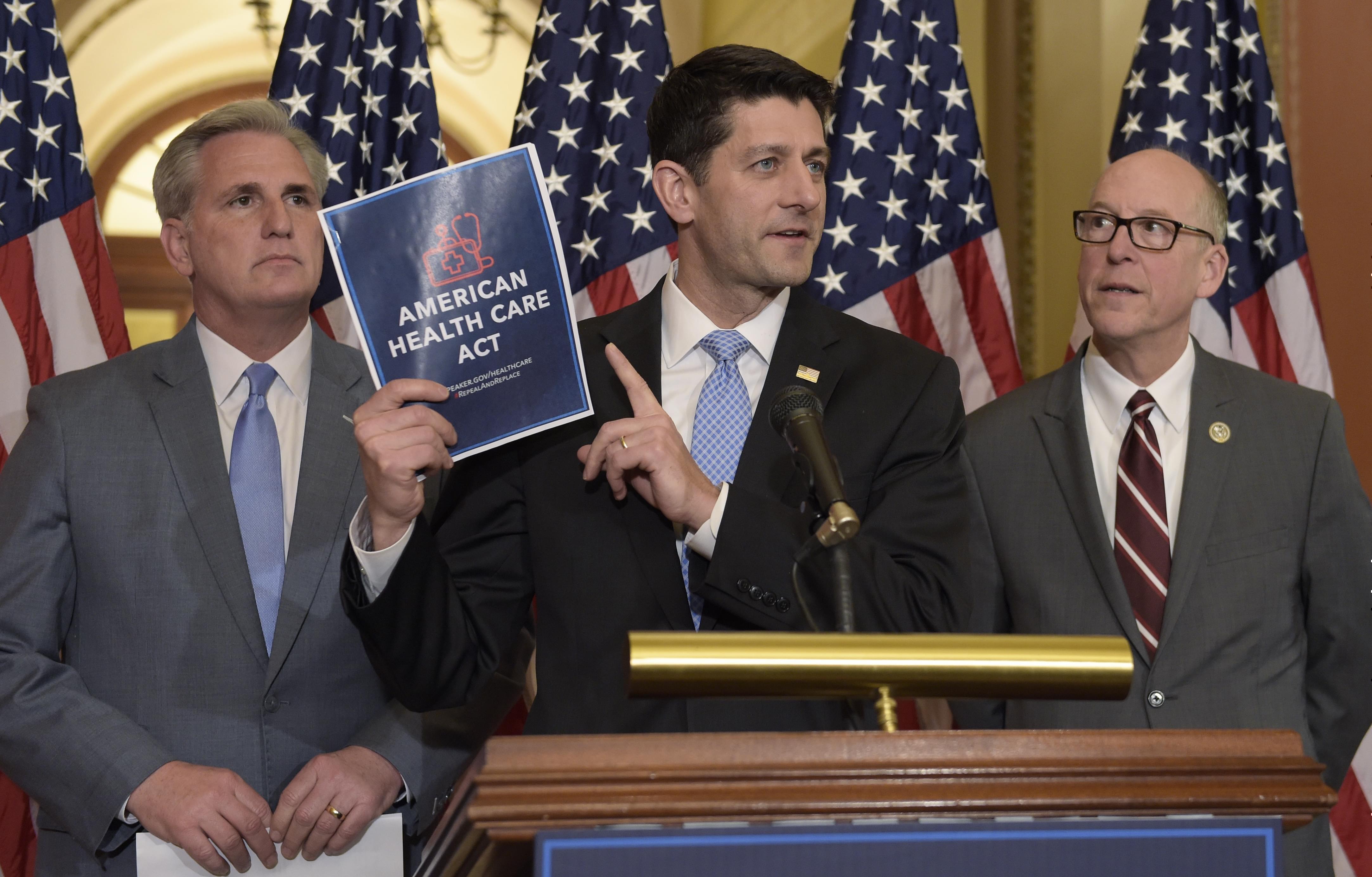 House Speaker Paul Ryan of Wis., center, standing with Energy and Commerce Committee Chairman Greg Walden, R-Ore., right, and House Majority Whip Kevin McCarthy, R-Calif., left, speaks during a news conference on the American Health Care Act on Capit