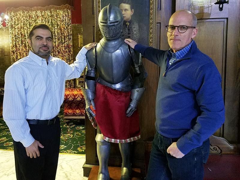 Developer Dionis Rodriguez and project manager Bill Walsh pose with a suit of armor in the Urbana Landmark Hotel