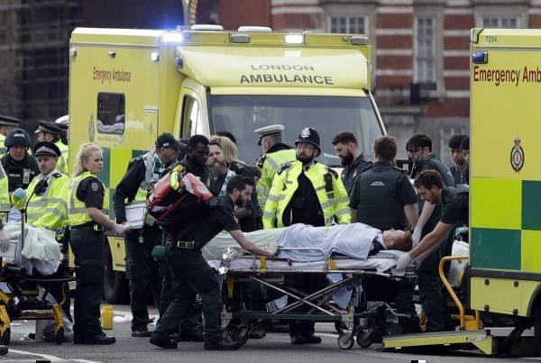 Emergency services transport an injured person to an ambulance, close to the Houses of Parliament in London, Wednesday, March 22, 2017. London police say they are treating a gun and knife incident at Britain's Parliament "as a terrorist inc