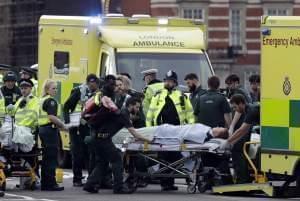 Emergency services transport an injured person to an ambulance, close to the Houses of Parliament in London, Wednesday, March 22, 2017. London police say they are treating a gun and knife incident at Britain's Parliament "as a terrorist inc