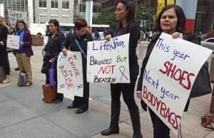 In this Oct. 1, 2015 file photo, advocates for victims of domestic abuse protest outside of state offices in downtown Chicago. 