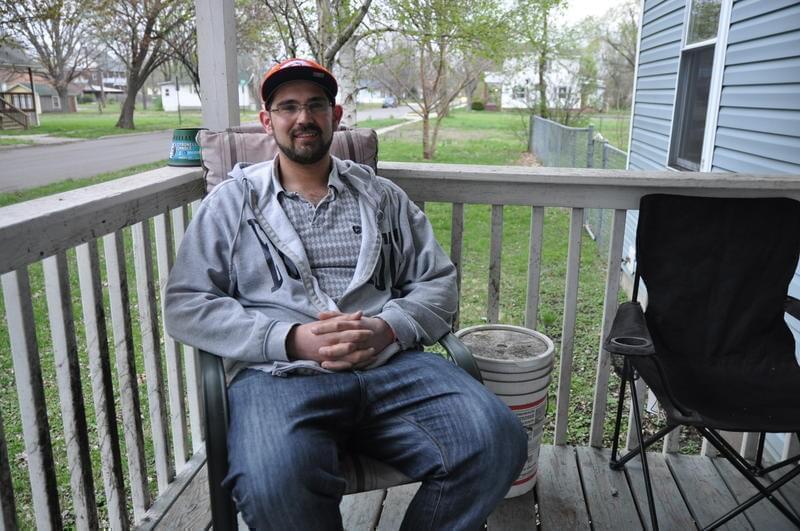 Sam Werkmeister, 30, sits on his porch in Granite City.