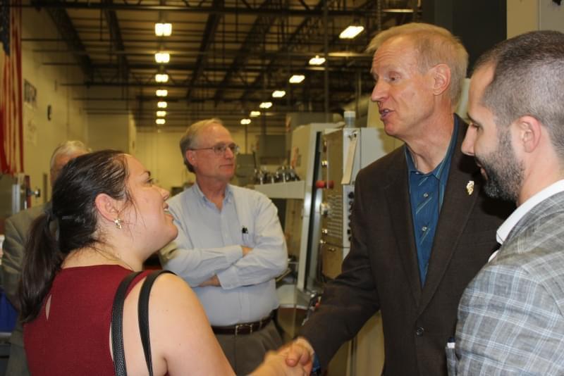 Rauner visits with supporters and employee at HL Precision Manufacturing in Champaign Wednesday.