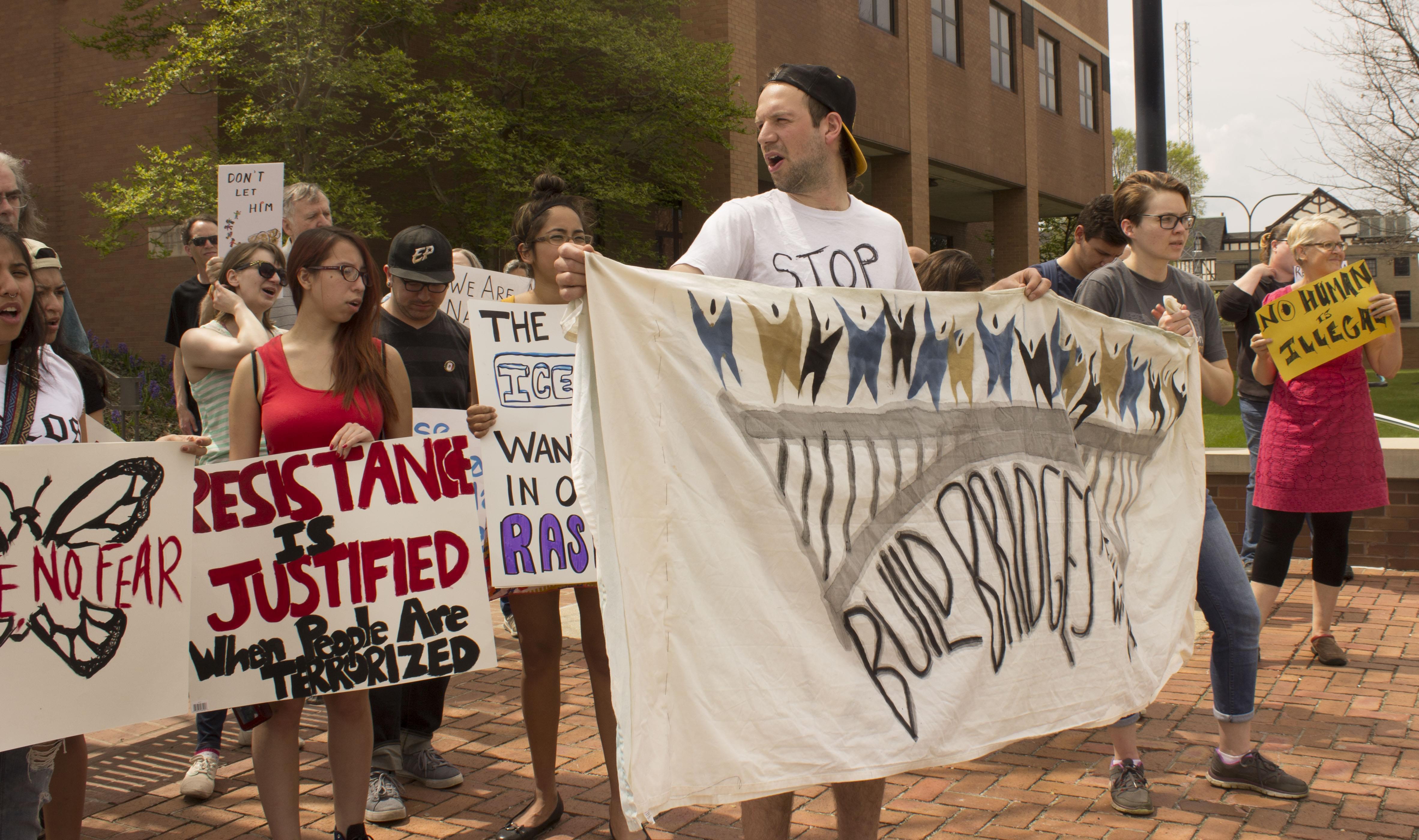 Members of the CU Immigration Forum rally outside the federal courthouse in Urbana Friday.