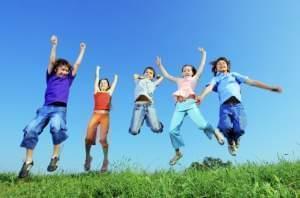 5 kids jumping in air outside