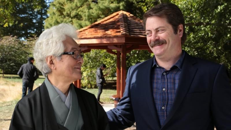 Actor Nick Offerman (right) stands with mentor and U of I professor emeritus Shozo Sato in front of a gazebo the Offerman helped to build for Japan House on the Urbana campus.