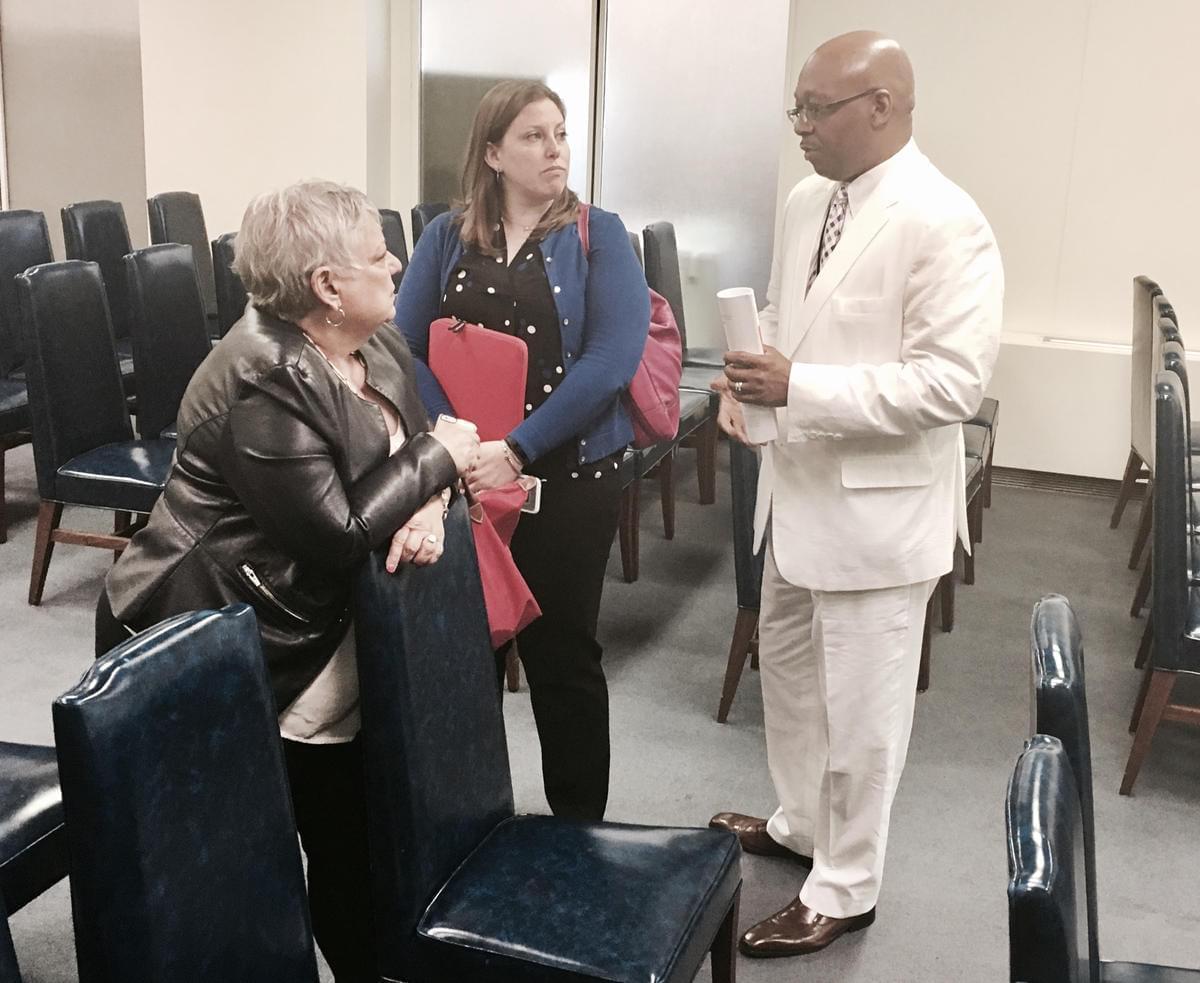 Rep. Will Davis (D-Homewood) chats with advocates representing suburban school districts Wednesday.