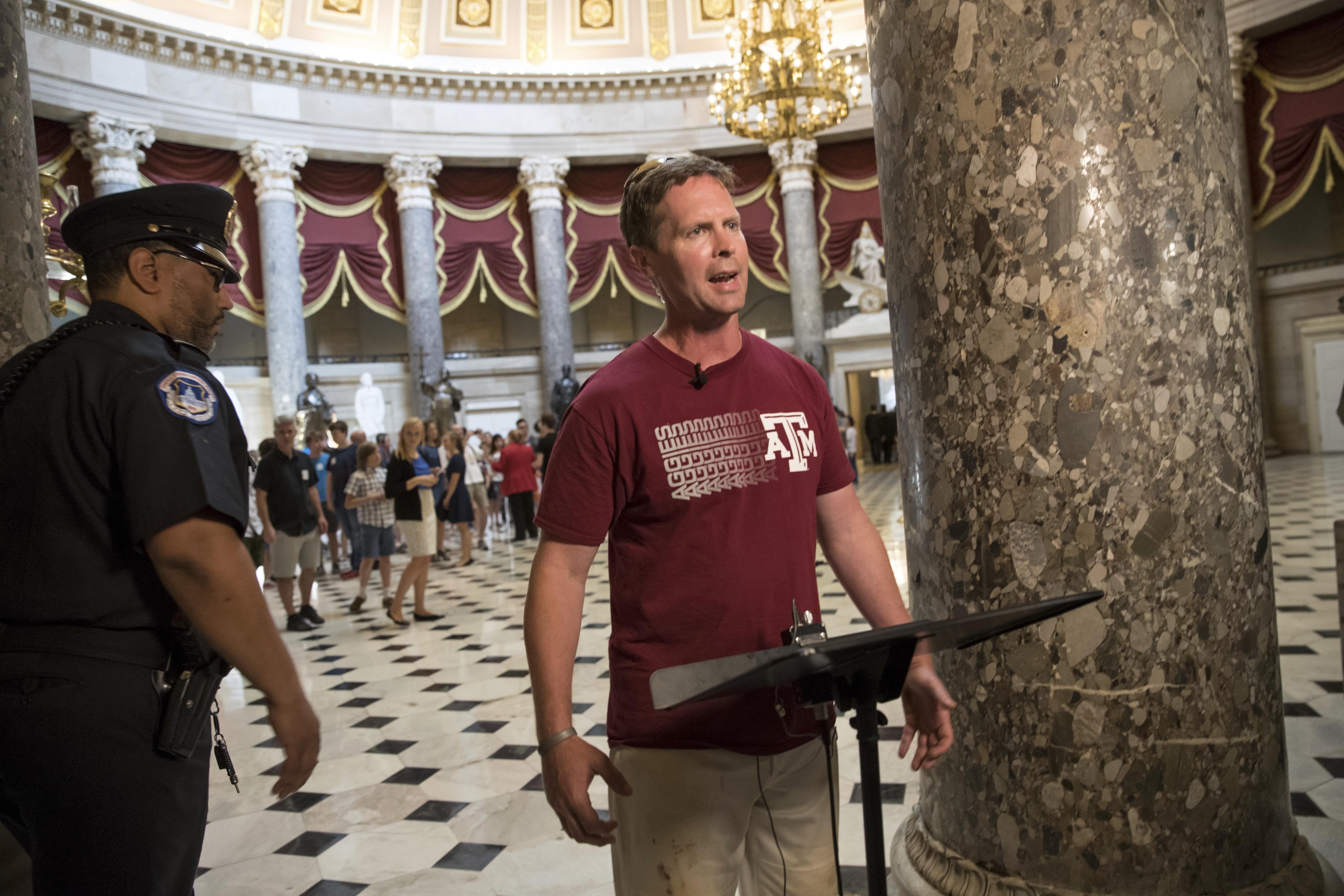 Rep. Rodney Davis, R-Ill., still wearing his baseball uniform, describes the scene on Capitol Hill in Washington, Wednesday.