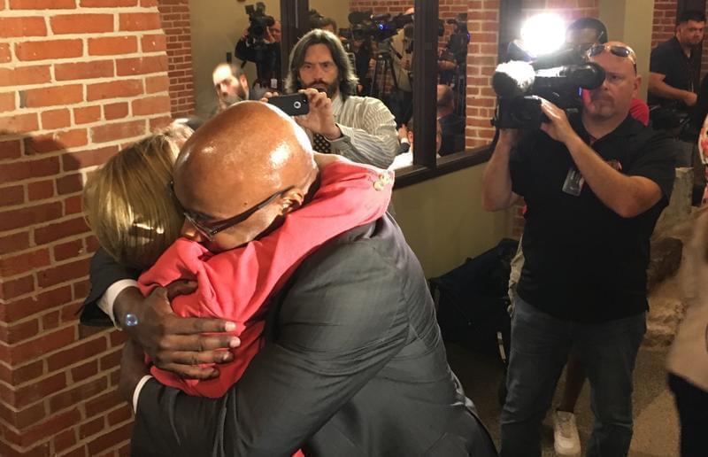 Several Democratic Senators, including Kwame Raoul of Chicago, were waiting to hug Republican Leader Christine Radogno after the news conference where she discuussed her resignation.