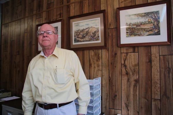 Earl Bullington, advisor for Focus Bank, which rescued the struggling Pemiscot County hospital in 2013. The pictures on his wall depict the farmland in Pemiscot County, Missouri.