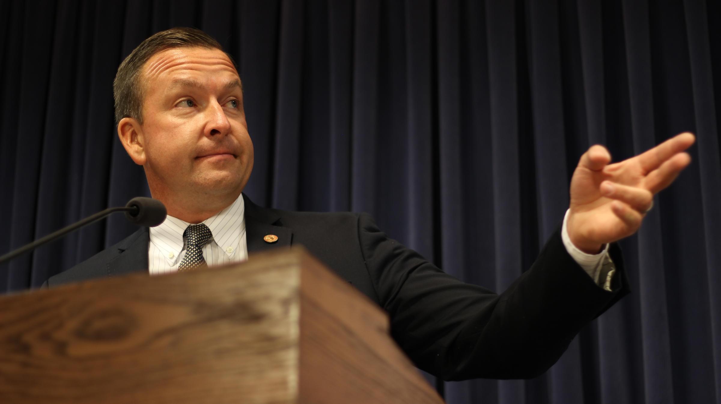 State Senator Andy Manar (D-Bunker Hill) speaks with reporters in Springfield.