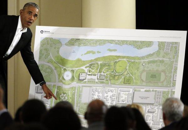 President Barack Obama points to a plan for the Obama Presidential Center in Chicago.