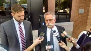 Christensen lawyers Evan and Tom Bruno meet the media outside Urbana Federal Court