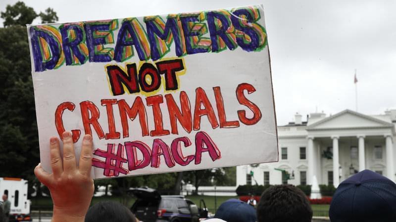 A woman holds up a signs in support of the Obama administration program known as Deferred Action for Childhood Arrivals, or DACA, during a rally on Aug. 15 at the White House.