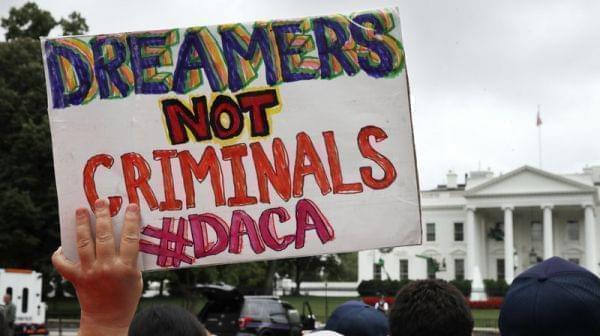 A woman holds up a signs in support of the Obama administration program known as Deferred Action for Childhood Arrivals, or DACA, during a rally on Aug. 15 at the White House. 