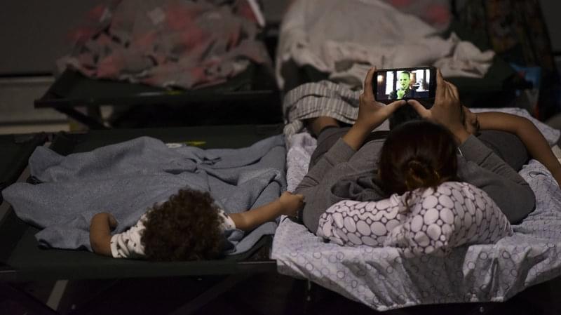 A woman and child rest on cots while waiting at Humacao Arena for the impact of Maria, a Category 4 hurricane that threatened to hit the eastern region of the island.
