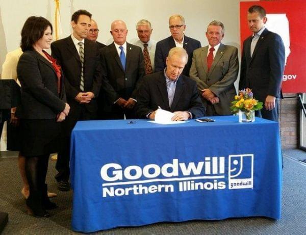 Gov. Bruce Rauner signs high school diploma legislation at Goodwill in Rockford.