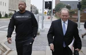 Lamont Evans, left, an assistant basketball coach at Oklahoma State University, and his attorney Trace Morgan leave the federal courthouse following a court appearance in Oklahoma City, Wednesday, Sept. 27, 2017. 
