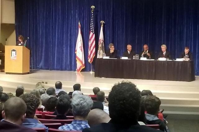 Democratic gubernatorial forum at Northern Illinois University. Left to right: WNIJ's Susan Stephens as moderator. Candidates Daniel Biss, Bob Daiber, Tio Hardiman, Chris Kennedy, and Alex Paterakis