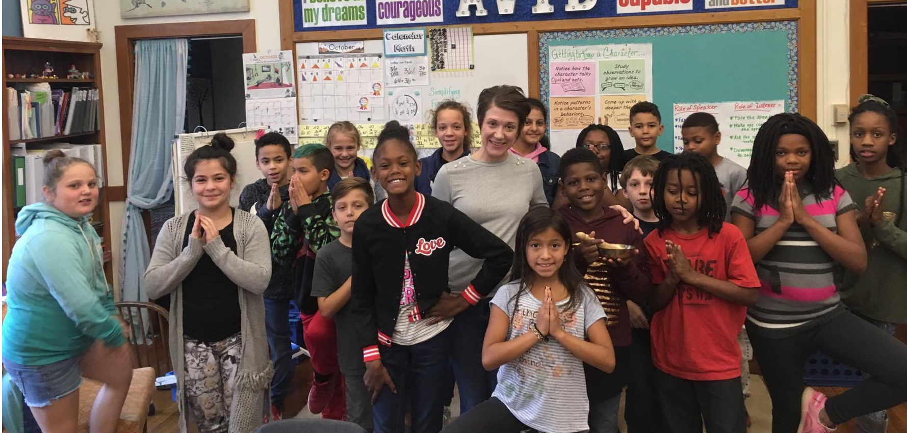 instructor Ashley Krstulovich surrounded by a 5th grade glass at Butler Elementary School.
