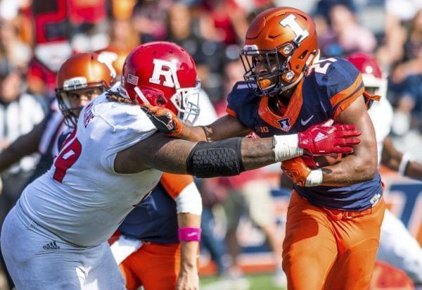 Illinois running back Ra'Von Bonner is tackled by Rutgers defensive lineman Kevin Wilkins.