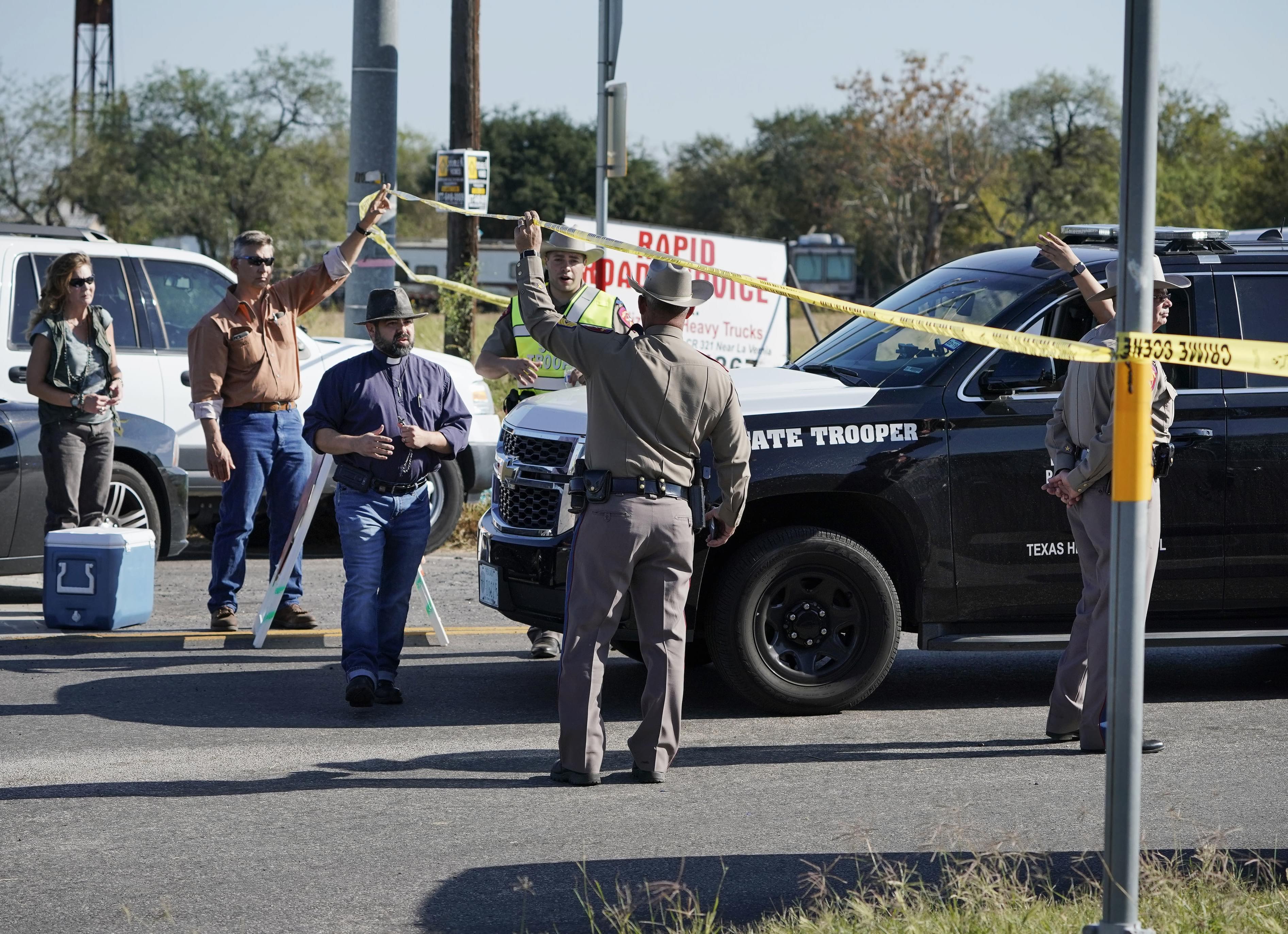 Law enforcement officers man a barricade near the First Baptist Church of Sutherland Springs after a fatal shooting, Sunday, Nov. 5, 2017, in Sutherland Springs, Texas.