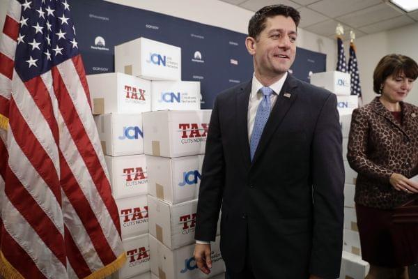 Speaker of the House Paul Ryan, R-Wis., followed at right by Rep. Cathy McMorris Rodgers, R-Wash., walks past boxes of petitions supporting the Republican tax reform bill that is set for a vote later this week as he arrives for a news conference on C