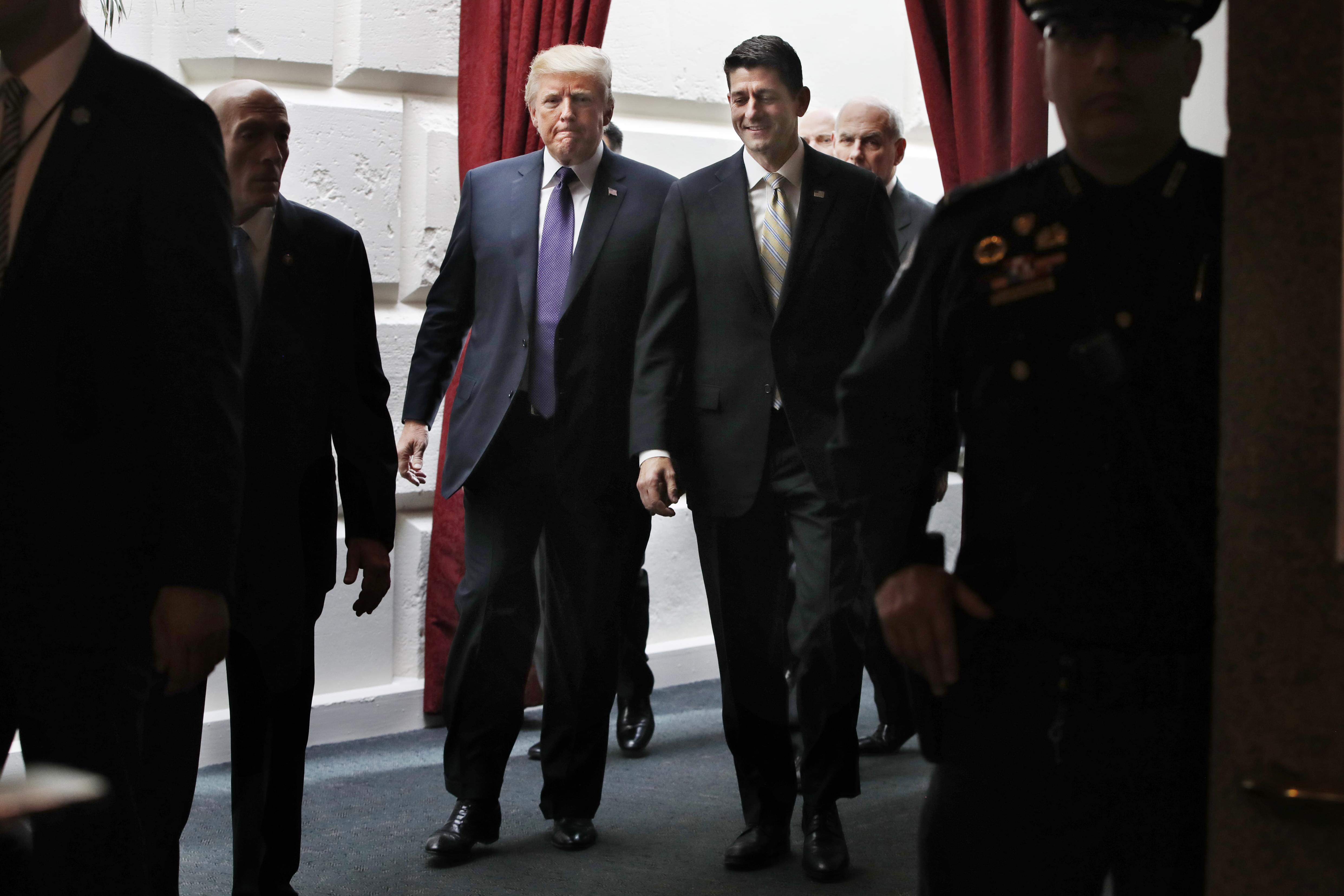 President Donald Trump, left, walks with House Speaker Paul Ryan of Wis., Thursday, Nov. 16, 2017, as they leave a meeting with House Republicans on Capitol Hill in Washington.