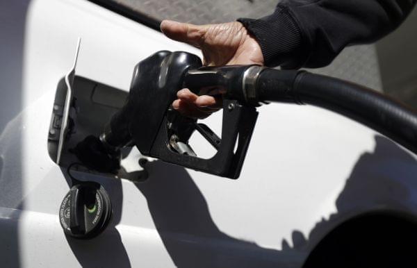 A person pumps gas into their car.
