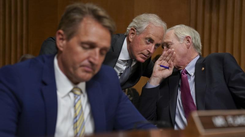 Sens. Jeff Flake, R-Ariz., Bob Corker, R-Tenn., and Ron Johnson, R-Wis., seen at a hearing earlier this month, held up floor action on Thursday evening over concerns about how to control the deficit if the GOP tax bill doesn't result in strong e