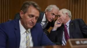 Sens. Jeff Flake, R-Ariz., Bob Corker, R-Tenn., and Ron Johnson, R-Wis., seen at a hearing earlier this month, held up floor action on Thursday evening over concerns about how to control the deficit if the GOP tax bill doesn't result in strong e