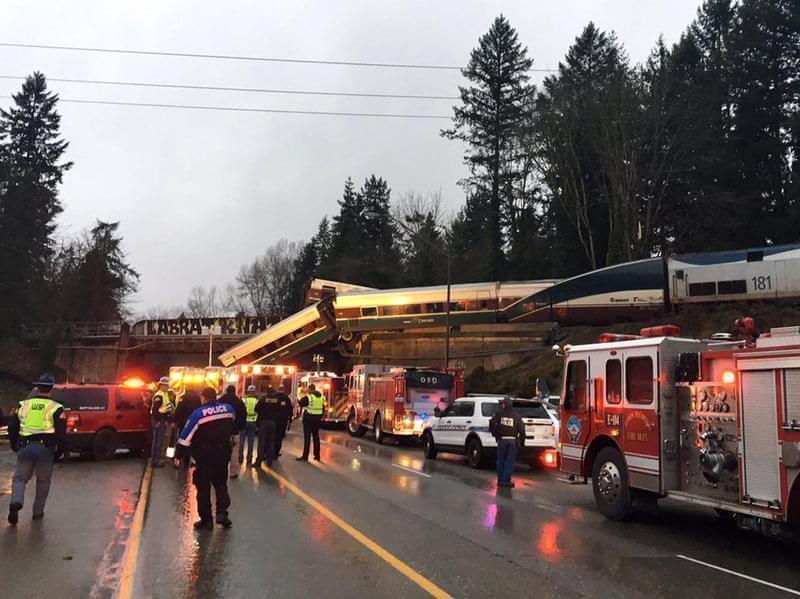 An Amtrak train derailed south of Seattle and fell partly onto Interstate 5, where authorities initially reported "injuries and casualties." 