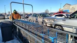 Seth Wills, 20, pushes a long row of carts at WalMart in Champaign on Tuesday, January 2, 2018.