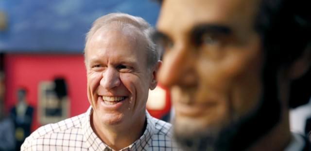 Gov. Bruce Rauner stands near a statue of Abraham Lincoln in Springfield on Jan. 11, 2015.