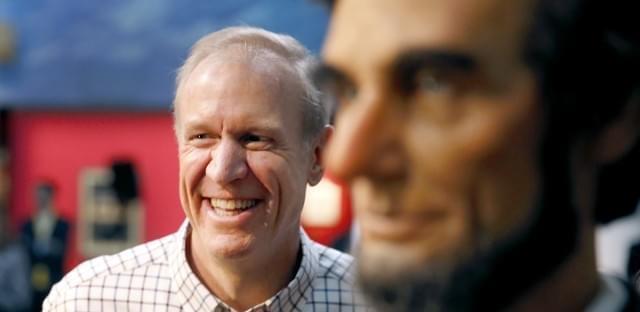 Gov. Bruce Rauner stands near a statue of Abraham Lincoln in Springfield on Jan. 11, 2015. 