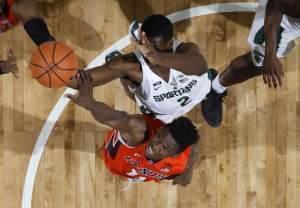 Michigan State's Jaren Jackson Jr., top, and Illinois' Greg Eboigbodin reach for a rebound during the second half of an NCAA college basketball game Tuesday, Feb. 20, 2018, in East Lansing, Mich. Michigan State won 81-61.