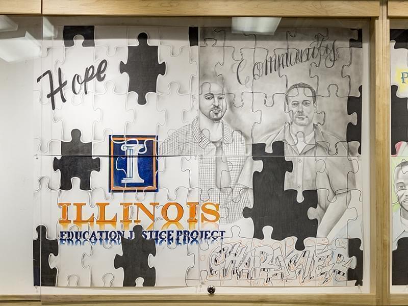 Five inmates at the Danville Correction Center created a mural composed of eight parts featuring the portraits of respected alums of the DCC college in prison program, the Education Justice Program. The artists behind the piece are also en
